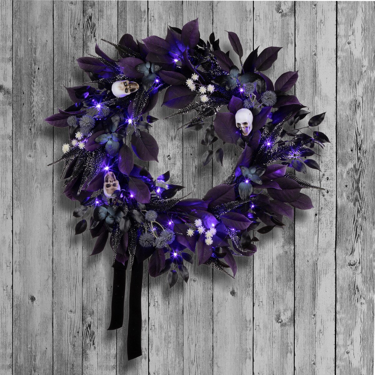 National Tree Company 26 Artificial Floral Mini Skull Wreath, 30 Purple LED Lights, Battery Operated